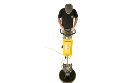 top view of a cleaner operating a single disc machine representing broombergs floor cleaning service