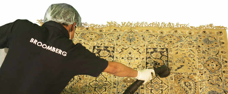 a carpet cleaner vacuuming a blue carpet using a vacuum cleaner