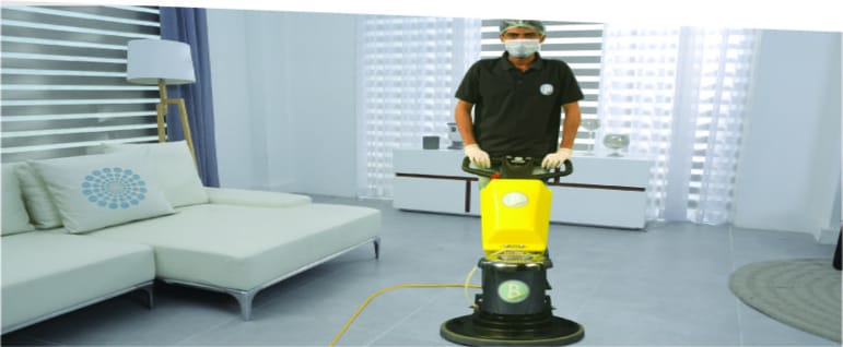 floor cleaner operating a single disc floor scrubbing machine to clean a wooden floor